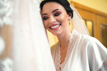 Naklejka premium Beautiful bride dressing up before wedding