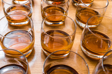 Glasses are filled with whiskey on the table