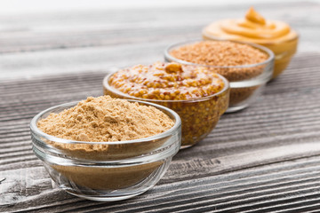 Set of different species of mustard on a rustic background