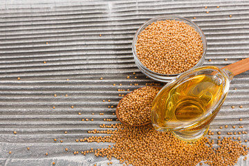 fresh mustard oil on a rustic background