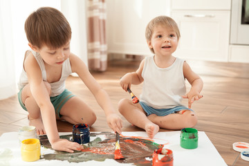  Two brothers paint on paper and on themselves.