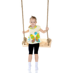 Little girl swinging on a swing