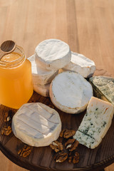 cheese plate. different cheeses on a wooden plate