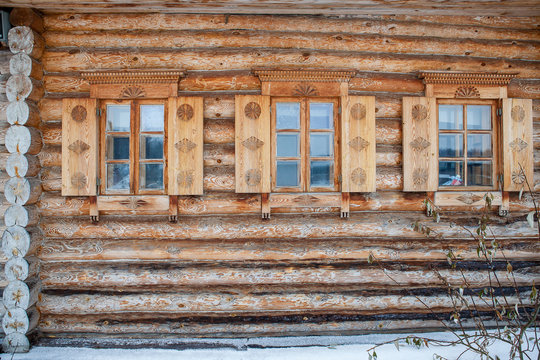 Three pretty carved windows of old wood house