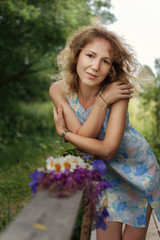 Fototapeta premium Portrait of a young woman with flowers