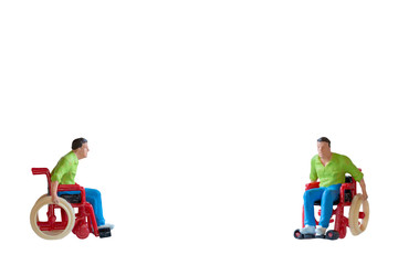 Miniature people Man in wheelchair  isolate on white background with clipping path