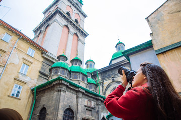 tourist woman taking picture of old european city. travel concept.