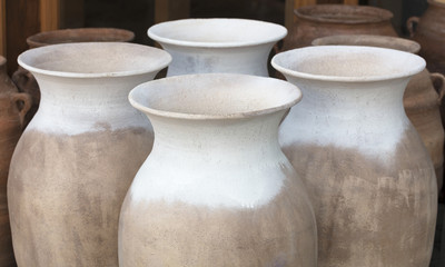 Fototapeta na wymiar Large clay amphorae for water in a row for sale