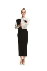 Full length portrait of a smiling female teacher holding a folder isolated against white background