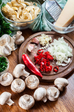 Ingredients ready for prepare tagliatelle pasta with champignon