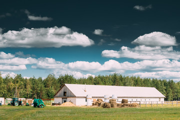 Countryside Rural Paddock For Horse, Shed Or Barn Or Stable With Haystacks In Late Summer Season.