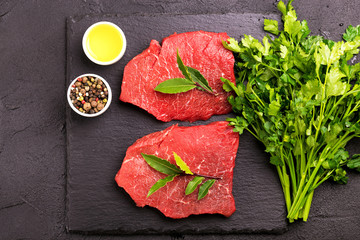 Fresh raw beef tenderloin and marbled steaks with seasoning