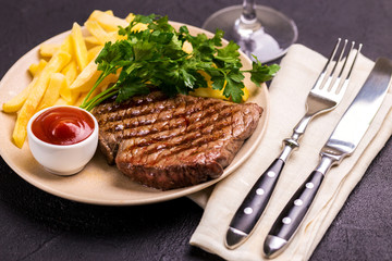 Grilled beef steak with tomatoes, french fries. Barbecue, bbq meat