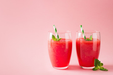 Watermelon smoothie with slice of fruit and leaf of mint