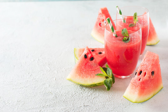 Watermelon smoothie with slice of fruit and leaf of mint