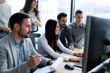 Young businesspeople working on computer in office