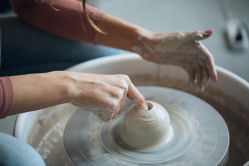 Handcrafted on a potter's wheel,Hands make clay from various items for home and sale in the store and at the exhibition, ceramic items are made in hand, the clay billet becomes a ceramic dish