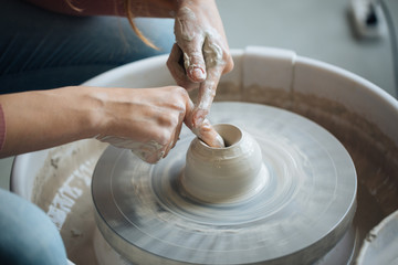 Handcrafted on a potter's wheel,Hands make clay from various items for home and sale in the store and at the exhibition, ceramic items are made in hand, the clay billet becomes a ceramic dish