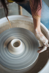 Handcrafted on a potter's wheel,Hands make clay from various items for home and sale in the store and at the exhibition, ceramic items are made in hand, the clay billet becomes a ceramic dish