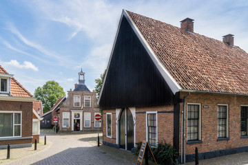 Fototapeta na wymiar Kerkplein (church square) and 'Keerweer' (street name) with School Museum in the city of Ootmarsum, NLD