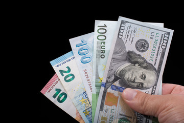 Hand holding American dollar  isolated on black background