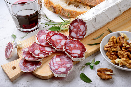 Salami, bread and glass of red wine