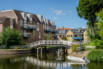 Fototapeta na wymiar Cityscape of Sneek at Looxmagracht (Looxma canal) and Zwarteweg at Badhuisgracht (Badhuis canal) and Prins Hendrikkade in the province Friesland, The Netherlands