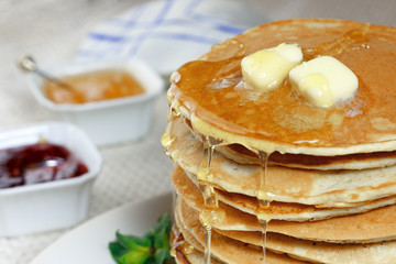 A stack of pancakes with blueberry and currant and blackberry