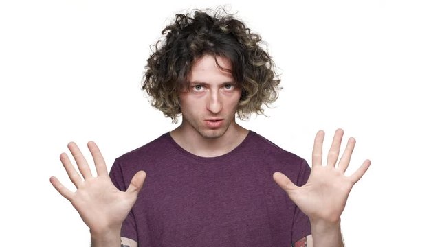 Portrait of strong-willed determined man shaking finger in denial and being definitely disagree, isolated over white background. Concept of emotions