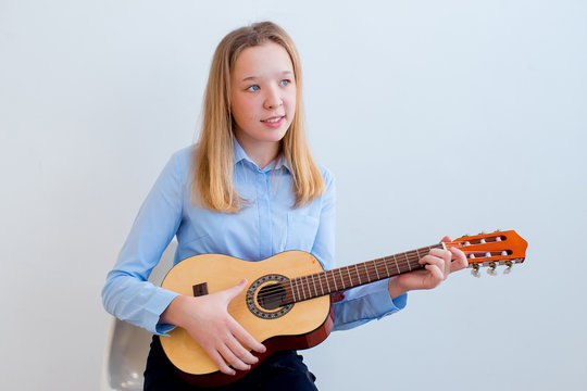 Girl playing a guitar