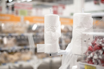 Rack Stand with free plastic bags - cellophane package in the supermarket store. Environmental pollution