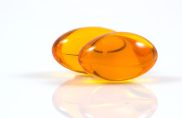 Vitamins supplementary food, Cod liver oil omega 3 gel capsules, Fish oil supplement capsule, vitamin e capsules isolated on a white background.