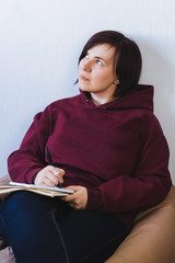 young woman with pen and note