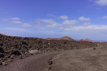 Volcanoes near the hiking trail in Timanfaya National Park on Lanzarote, the Canary Islands