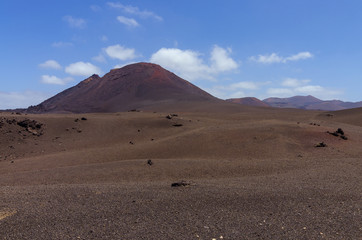 Volcanoes near the hiking trail in Timanfaya National Park on Lanzarote, the Canary Islands