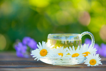 Crystal cup with green tea on table
