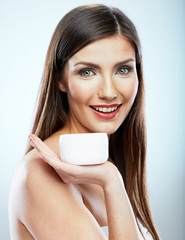 Obraz na płótnie Canvas Beauty portrait of smiling girl holding skin cream.