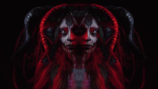 A woman with horns in the image of a demoness dances in front of the camera, montage