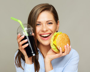 Happy woman eatin American classic fast food.