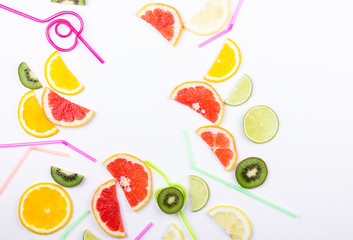 Citrus slices and straws on white