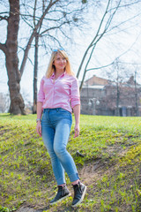 A woman of plus size, American or European appearance walks at city streets enjoying life. A young...