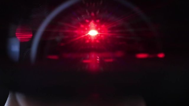 red laser barcode scanner close up, scanning lense