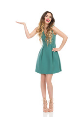 Laughing Elegant Woman In Mini Dress And High Heels Is Presenting