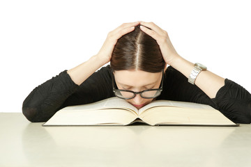 Studio portrait of young woman in front of big book on the table, don't feel like studying concept