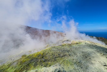Sulphur gas coming out of the edge of the volcanic crater on the Vulcano island in the Aeolian islands, Sicily, Italy
