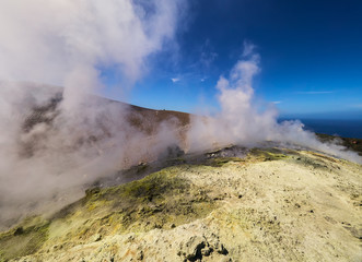 Sulphur gas coming out of the edge of the volcanic crater on the Vulcano island in the Aeolian islands, Sicily, Italy
