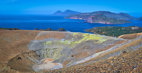 View of the volcanic crater and Lipari and Salina islands from the top of the volcano of the Vulcano island in the Aeolian islands, Sicily, Italy
