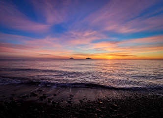 Beautiful sunrise withe the Stromboli and Panarea islands seen from the Salina island in the...