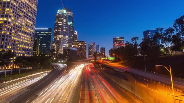 Cinematic hyper lapse ( timelapse in motion ) view of Los Angeles Downtown and 110 freeway traffic while changing from day to night