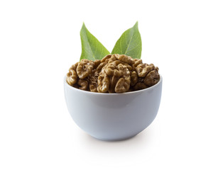 Kernels walnuts with leaves isolated on white. Walnuts in a bowl isolated on white background. Walnuts with copy space for text on a white background